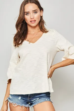 A Knit Top With Deep V Neckline And Yoke Design in Vanilla